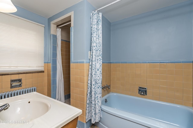 full bath with a sink, radiator heating unit, tile walls, curtained shower, and a tub to relax in