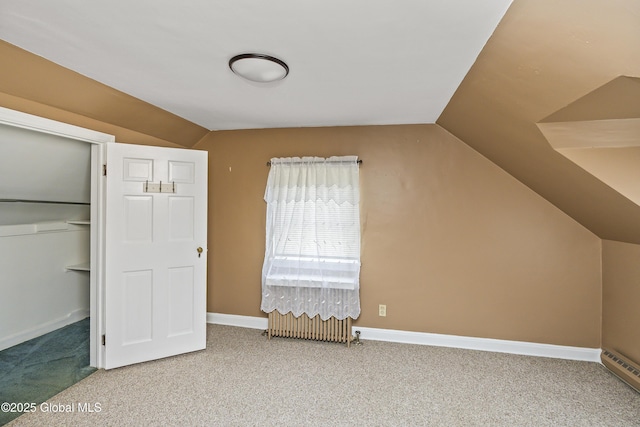 bonus room with baseboards, carpet, and vaulted ceiling