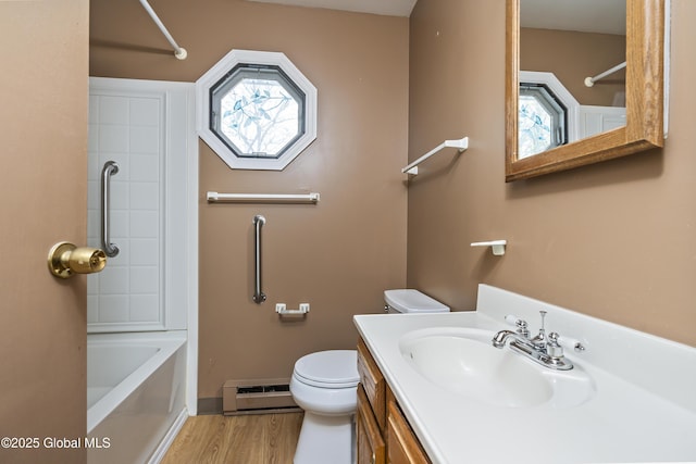 bathroom featuring vanity, wood finished floors, shower / bathtub combination, toilet, and a baseboard heating unit