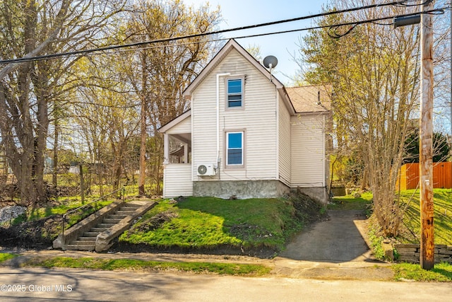 view of front of property with stairs, ac unit, and fence