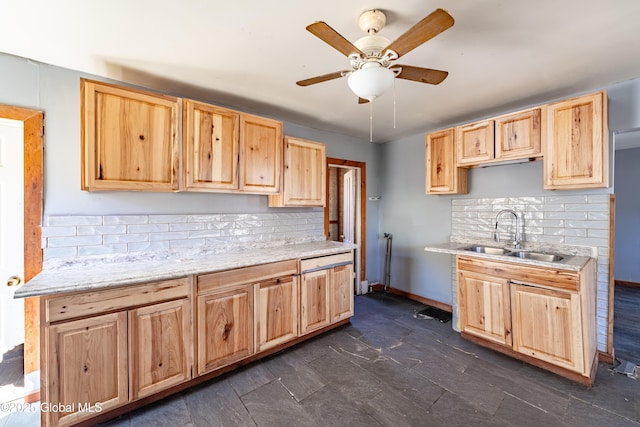 kitchen featuring light brown cabinetry, backsplash, and a sink