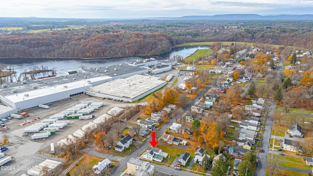 drone / aerial view featuring a water view and a forest view