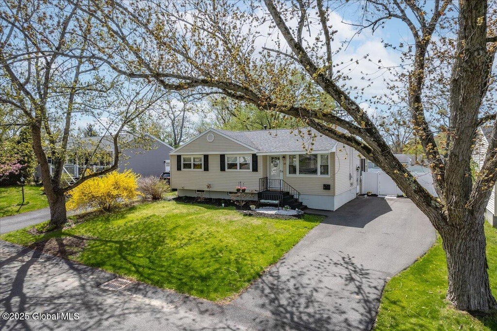 view of front of house with driveway and a front lawn