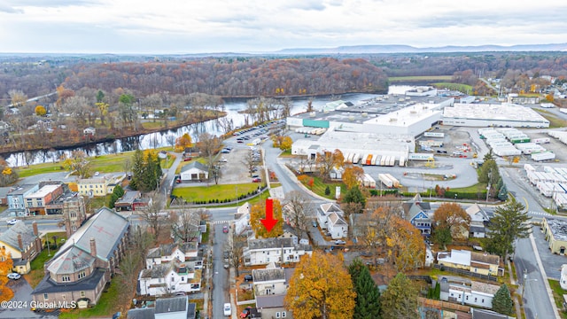 bird's eye view with a water view and a forest view