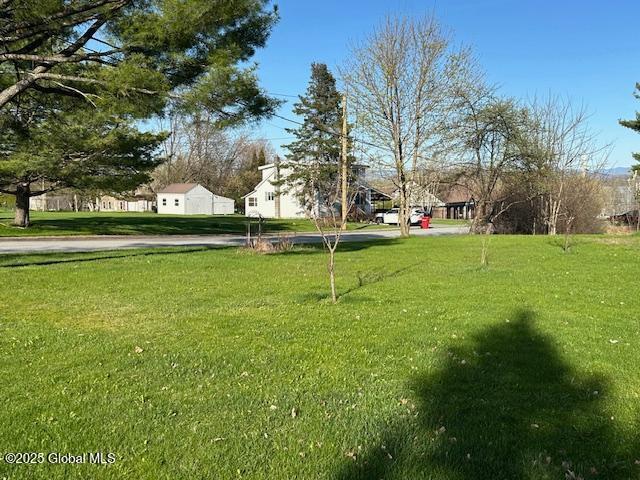 view of home's community featuring a lawn and a residential view