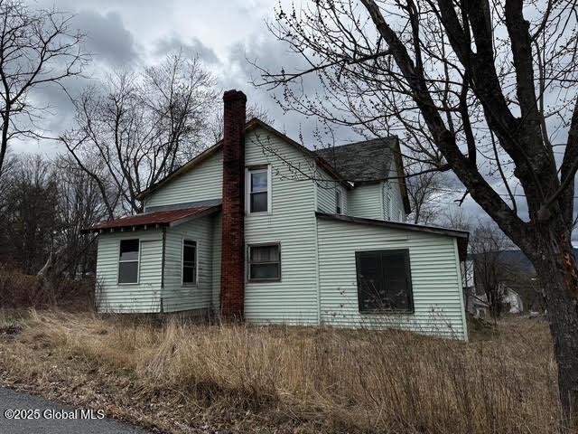 view of side of property featuring a chimney