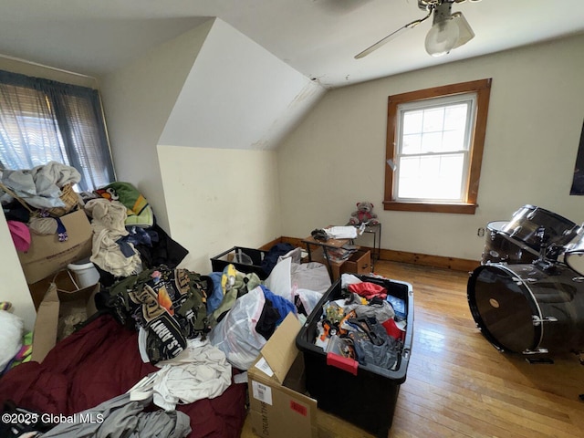 bonus room featuring baseboards, ceiling fan, vaulted ceiling, and hardwood / wood-style flooring