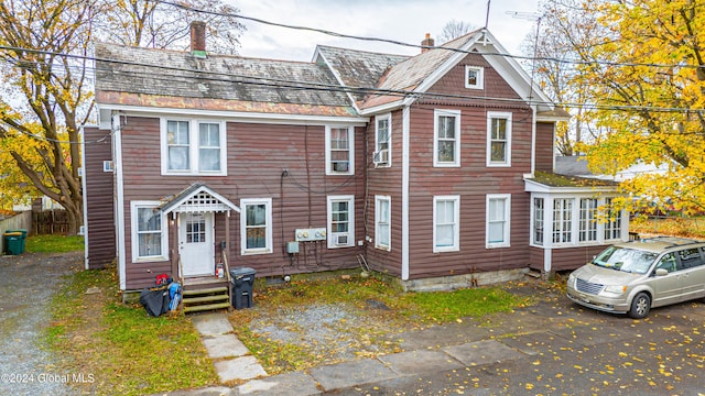 townhome / multi-family property with entry steps and a chimney