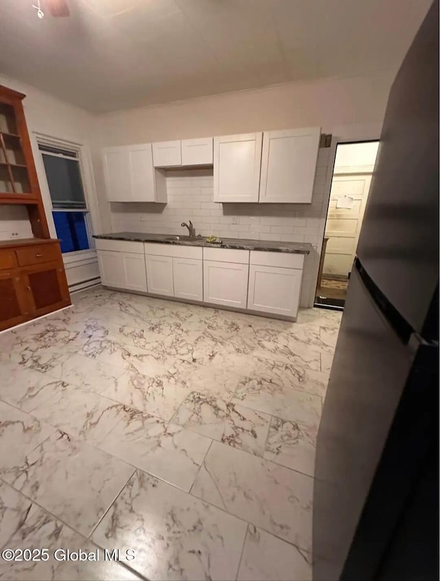 28 Pulaski St, Amsterdam, NY 12010 - kitchen featuring freestanding refrigerator, marble finish floor, dark countertops, and white cabinetry