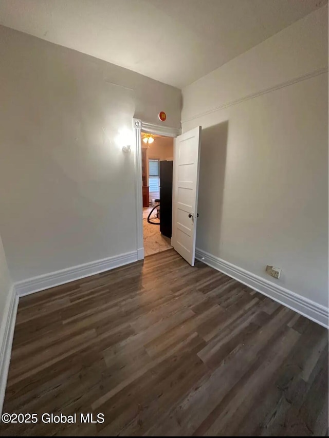 28 Pulaski St, Amsterdam, NY 12010 - spare room with baseboards and dark wood-type flooring