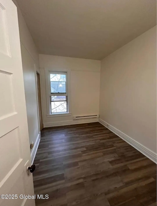 28 Pulaski St, Amsterdam, NY 12010 - empty room featuring baseboards, a baseboard heating unit, and dark wood-style floors