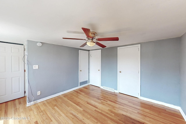 unfurnished bedroom with baseboards, a ceiling fan, and light wood finished floors