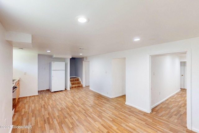 unfurnished room with recessed lighting, stairway, baseboards, and light wood finished floors