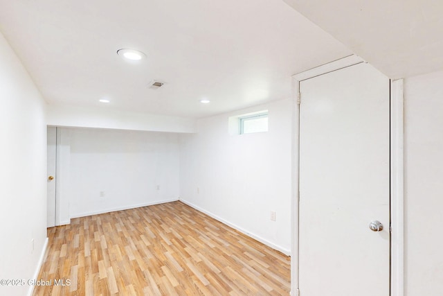 below grade area with light wood-style floors, recessed lighting, baseboards, and visible vents