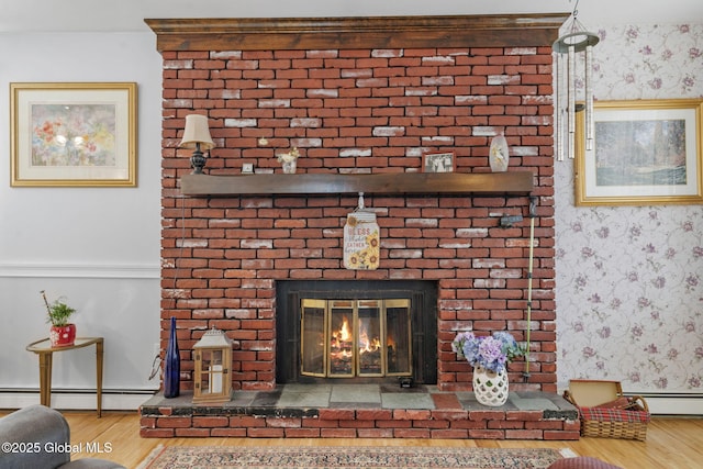 details with wood finished floors, a fireplace, baseboards, wallpapered walls, and a baseboard radiator