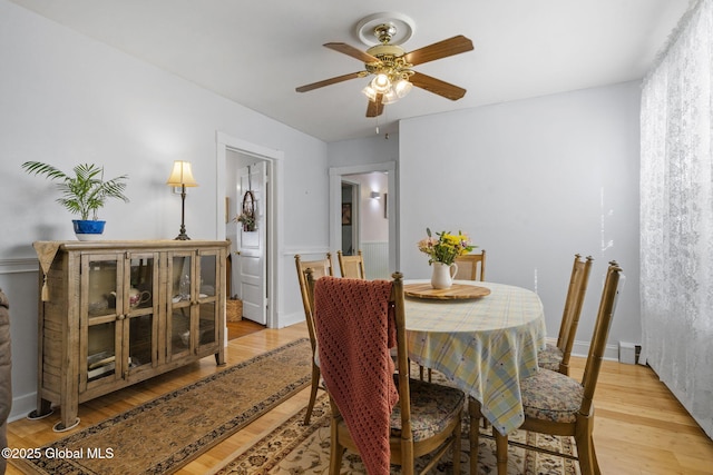 dining room with ceiling fan and light wood-type flooring