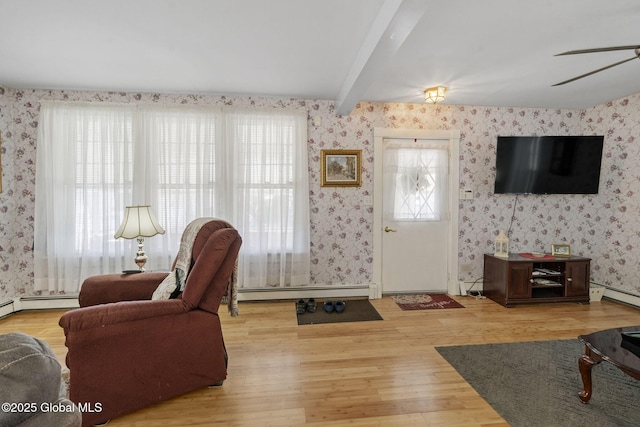 living room with wallpapered walls, a wealth of natural light, and wood finished floors