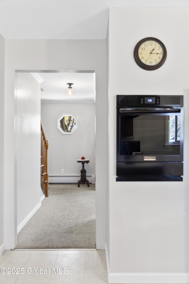 hall with tile patterned flooring, stairway, carpet floors, baseboards, and a baseboard radiator