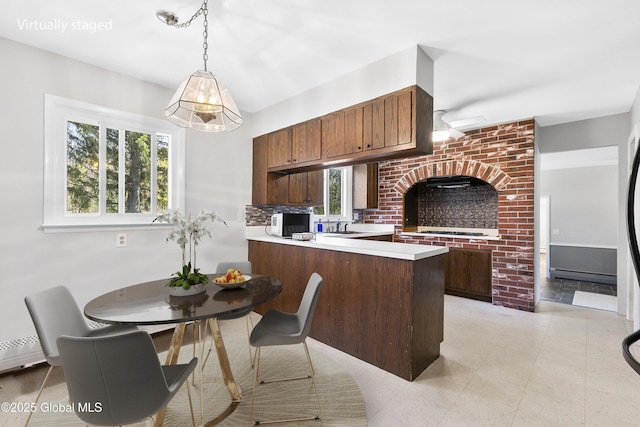 27 Aaron Dr, Catskill, NY 12414 - kitchen with light countertops, a ceiling fan, a peninsula, baseboard heating, and pendant lighting