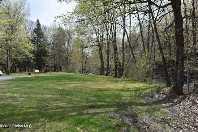 view of yard with a view of trees