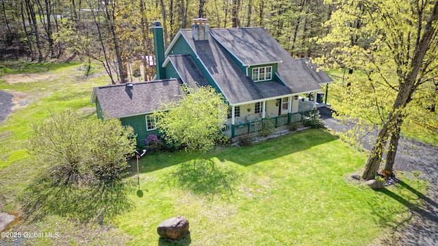 bird's eye view with a wooded view