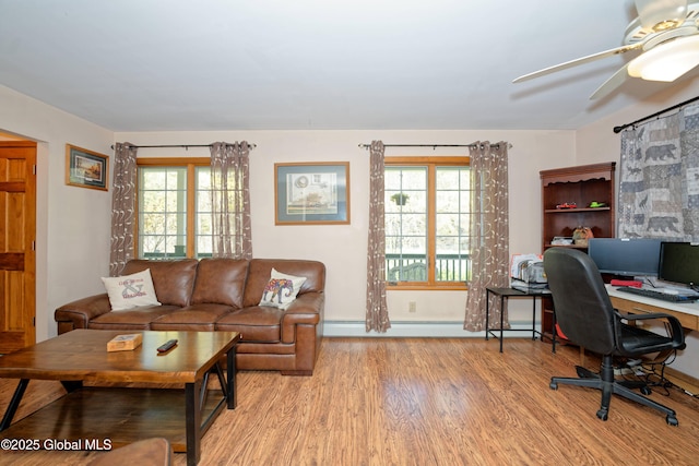 home office featuring baseboards, ceiling fan, baseboard heating, and wood finished floors