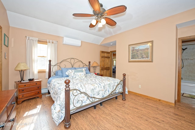 bedroom with baseboards, a wall mounted AC, a baseboard radiator, and light wood-style floors