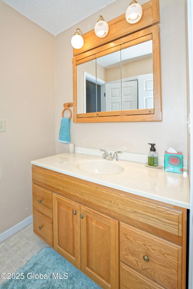 bathroom featuring vanity and baseboards