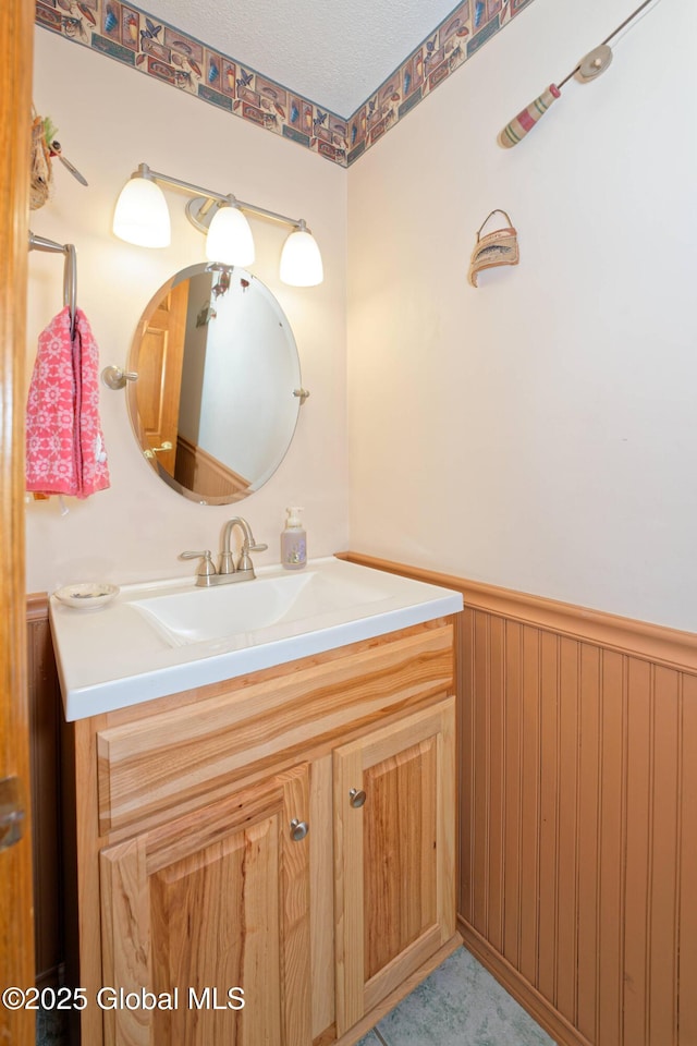 bathroom with vanity and wainscoting