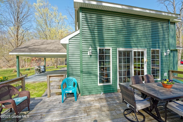 wooden terrace featuring outdoor dining area
