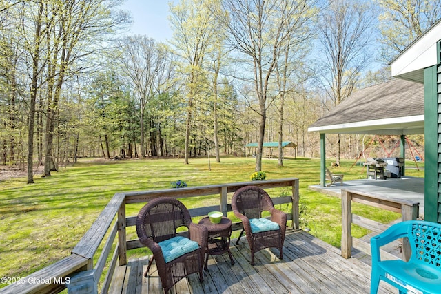 wooden deck featuring a yard