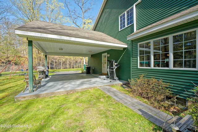 exterior space with a grill, driveway, and a carport