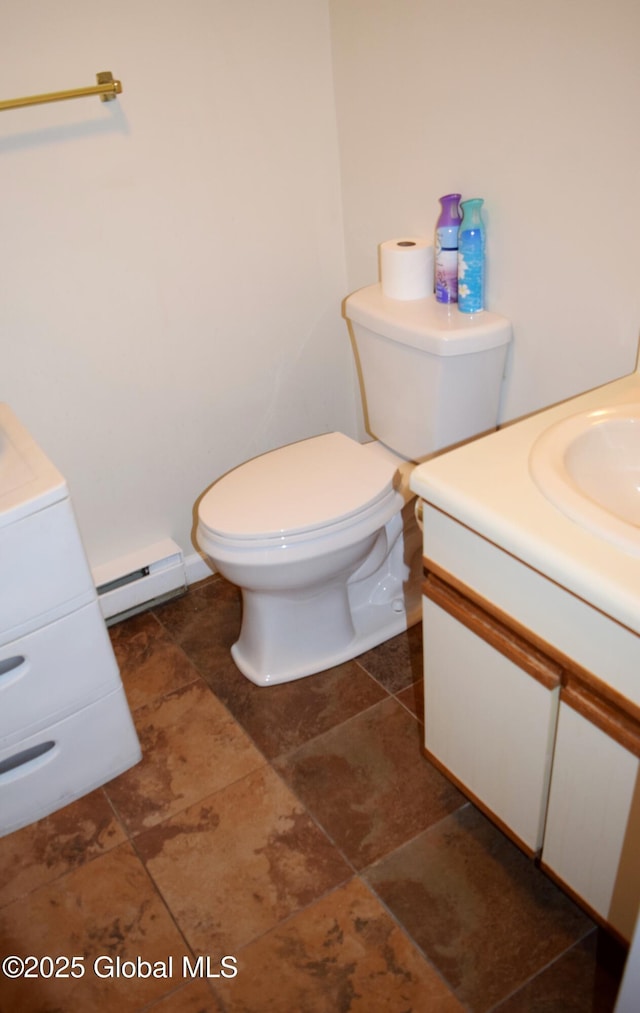 bathroom with toilet, baseboard heating, and vanity