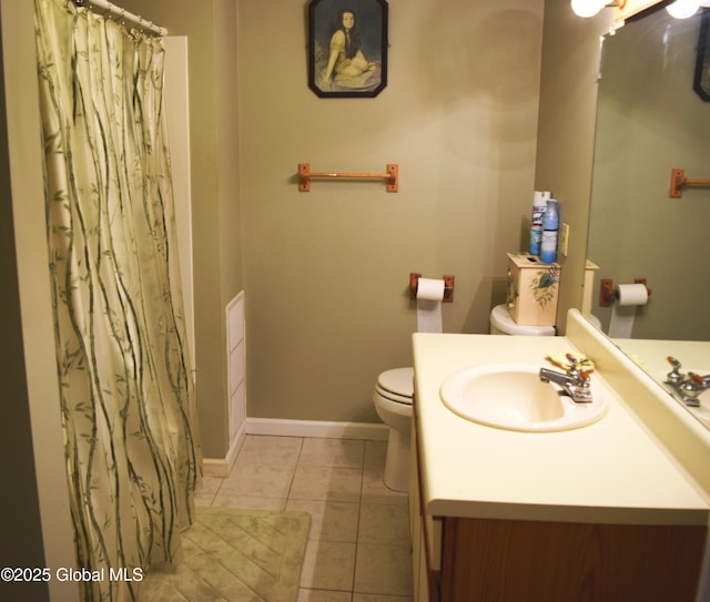 bathroom with vanity, toilet, tile patterned floors, baseboards, and a shower with curtain