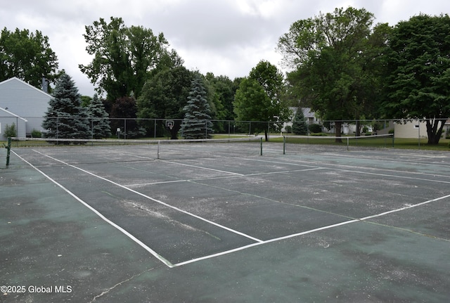 view of tennis court featuring fence
