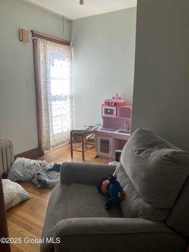 interior space with wood finished floors and radiator heating unit