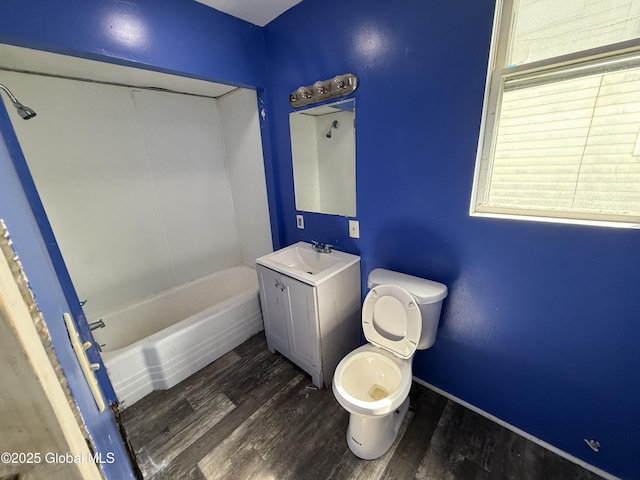25-27 Caroline St, Amsterdam, NY 12010 - bathroom with wood finished floors, vanity, baseboards, toilet, and a tub to relax in