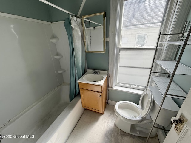 25-27 Caroline St, Amsterdam, NY 12010 - bathroom featuring a healthy amount of sunlight, vanity, toilet, and shower / tub combo