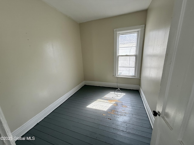 25-27 Caroline St, Amsterdam, NY 12010 - spare room featuring baseboards and dark wood-style floors