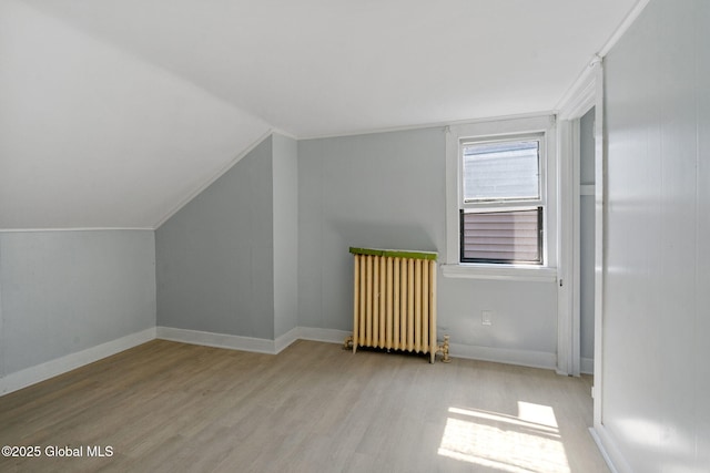 502 1st St, Albany, NY 12206 - bonus room featuring wood finished floors, radiator heating unit, lofted ceiling, and baseboards
