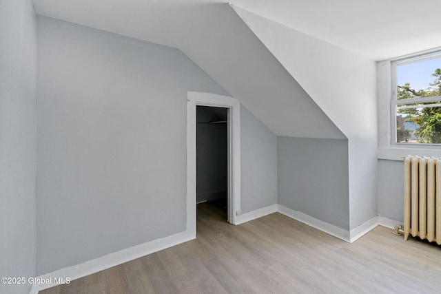 502 1st St, Albany, NY 12206 - bonus room featuring radiator heating unit, wood finished floors, lofted ceiling, and baseboards
