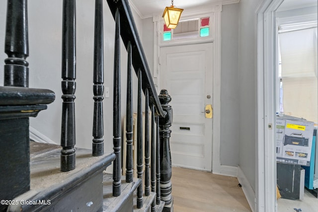 502 1st St, Albany, NY 12206 - foyer entrance with stairs, light wood-style flooring, crown molding, and baseboards