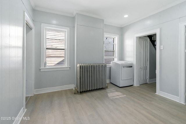 502 1st St, Albany, NY 12206 - unfurnished bedroom with radiator heating unit, washer / clothes dryer, light wood-style floors, ornamental molding, and baseboards