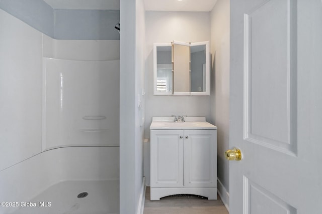502 1st St, Albany, NY 12206 - full bath with a shower stall, vanity, wood finished floors, and baseboards