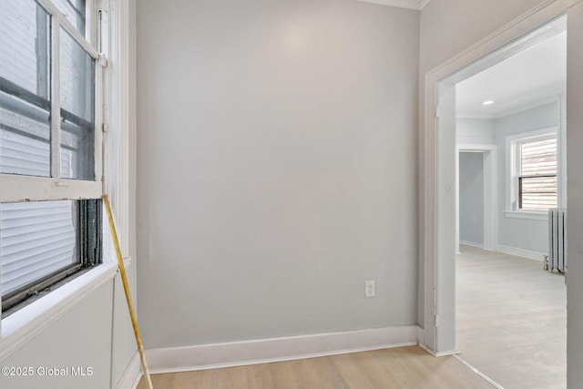 502 1st St, Albany, NY 12206 - spare room with radiator, light wood finished floors, crown molding, and baseboards