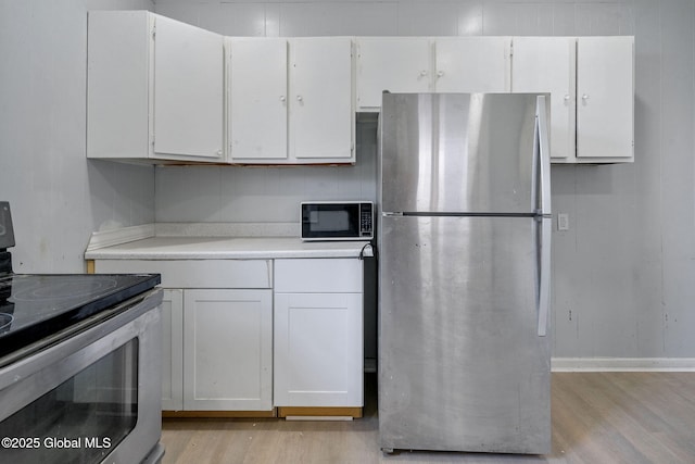 502 1st St, Albany, NY 12206 - kitchen with stainless steel appliances, light wood-type flooring, white cabinetry, and light countertops