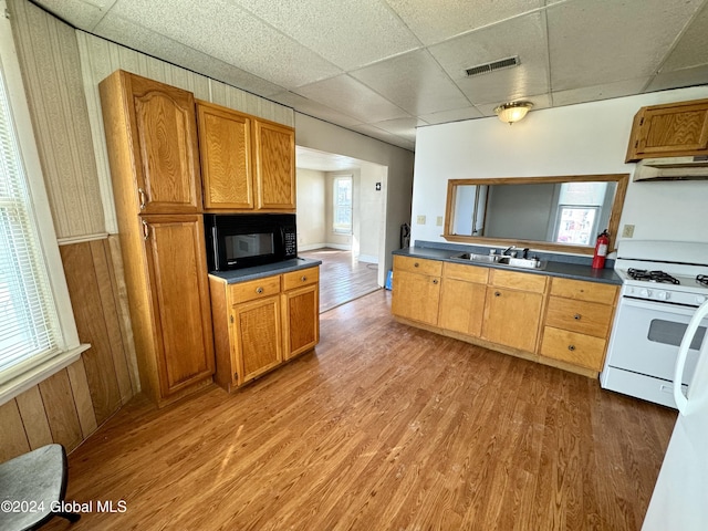 29 Park St, Fonda, NY 12068 - kitchen with visible vents, black microwave, dark countertops, white gas stove, and a sink