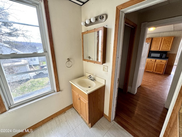 29 Park St, Fonda, NY 12068 - bathroom featuring baseboards, wood finished floors, and vanity