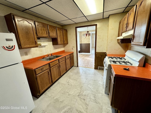 29 Park St, Fonda, NY 12068 - kitchen featuring a sink, a drop ceiling, under cabinet range hood, and white appliances