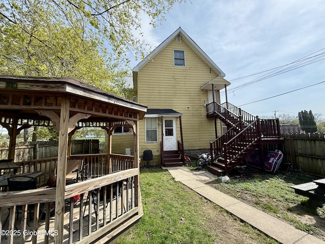 29 Park St, Fonda, NY 12068 - rear view of property featuring a lawn, a deck, a gazebo, fence, and entry steps